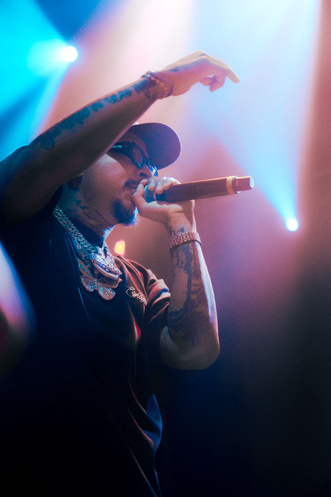 Luciano on stage in blue light